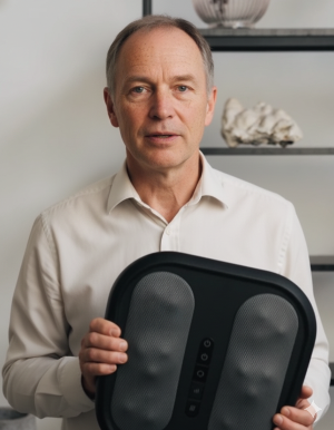 Man holding a BodyRevive 3D Pro-Therapy Heated Massager in an indoor setting